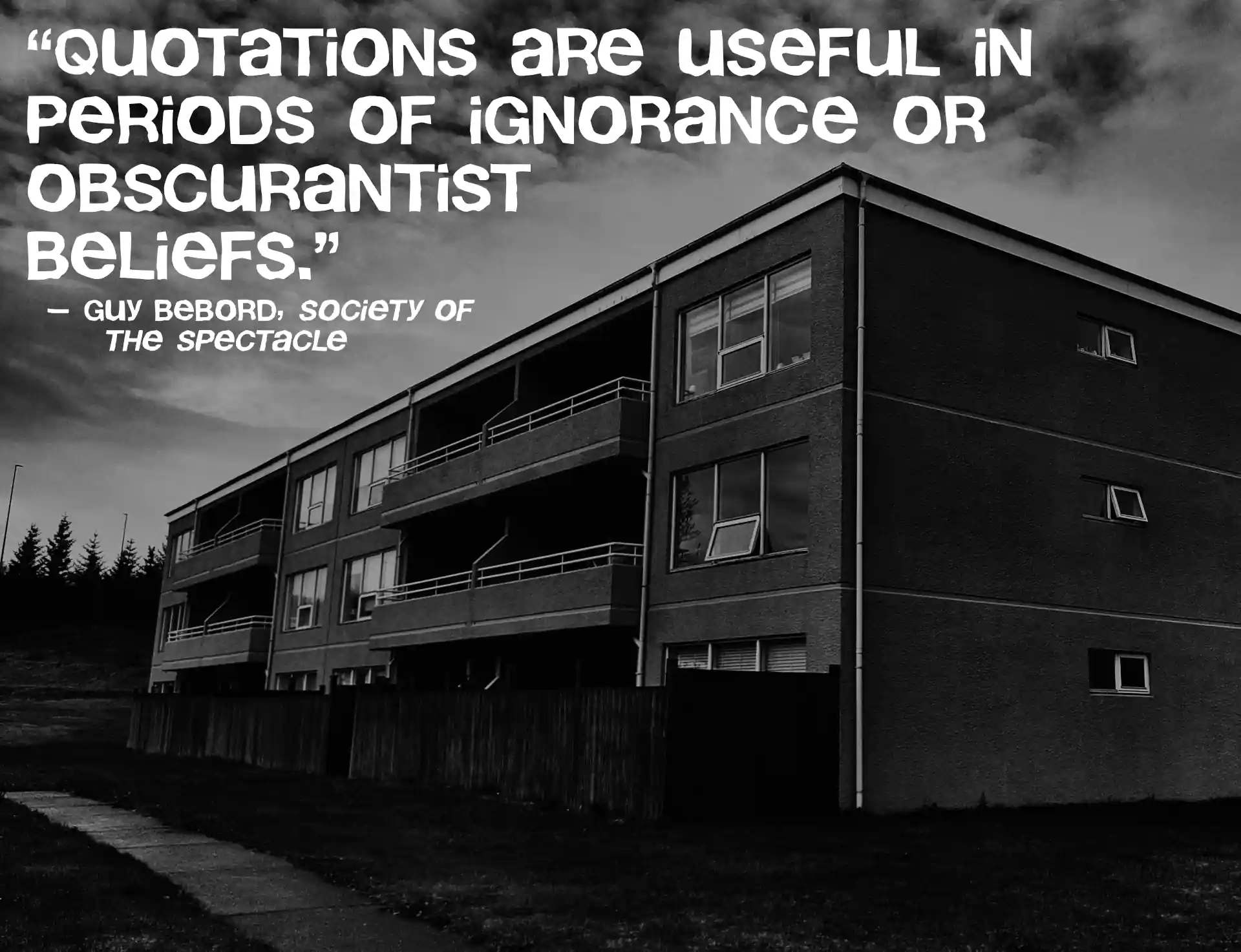 Black and white photo of an oblong tower block with the text: Quotations are useful in periods of ignorance or obscurantist beliefs, by Guy Debord, from Society Of The Spectacle